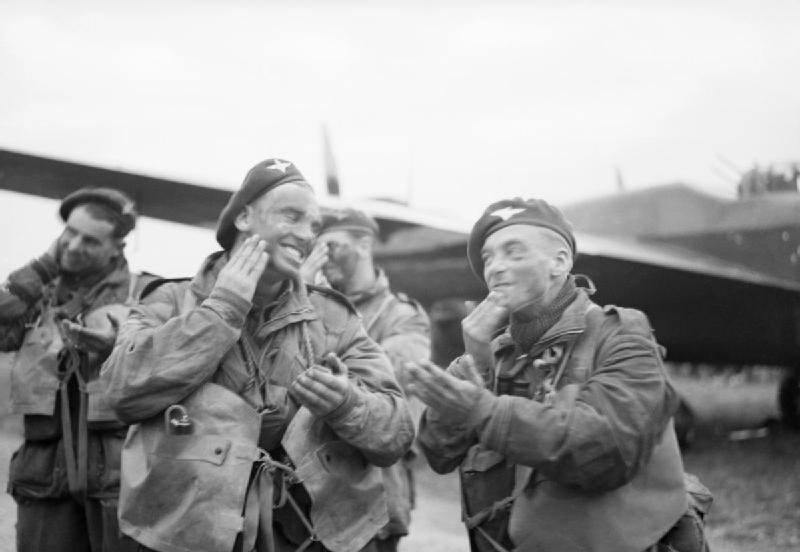 Paratroops_of_6th_Airborne_Division_blackening_their_faces_in_front_of_an_Albemarle_aircraft_at_RAF_Harwell,_5_June_1944._H39066